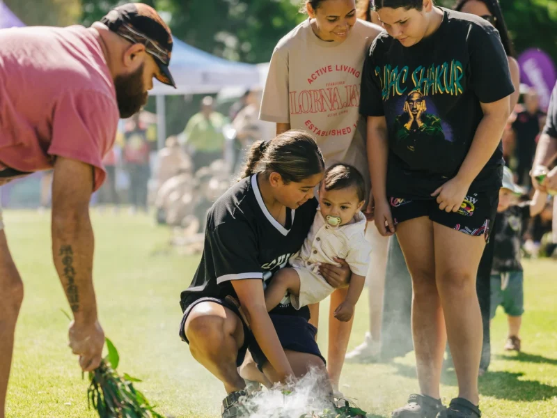 Woman holding a child surrounded by other people